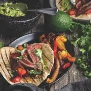 Seared sharp-tailed grouse meat served in fajitas on tortillas with peppers and cilantro