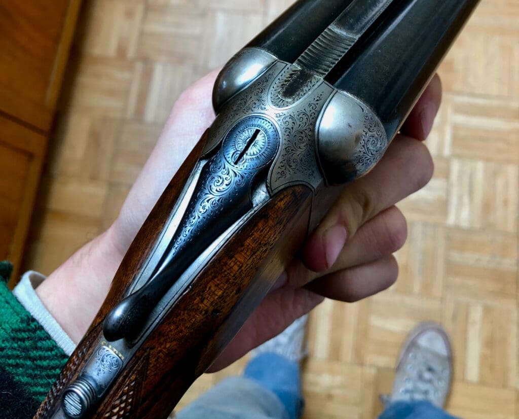 The author shows the engraving detail on a vintage shotgun.