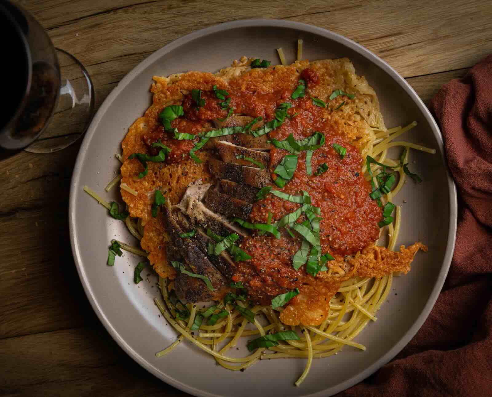 Roasted pheasant in a hearty marinara sauce on spaghetti