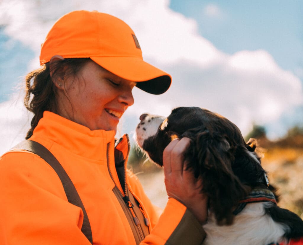 A woman with a Springer Spaniel showing its good temperment 