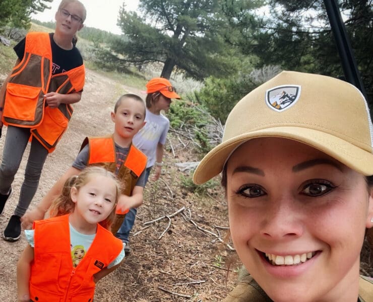 A mother shows her kids how to upland hunt.