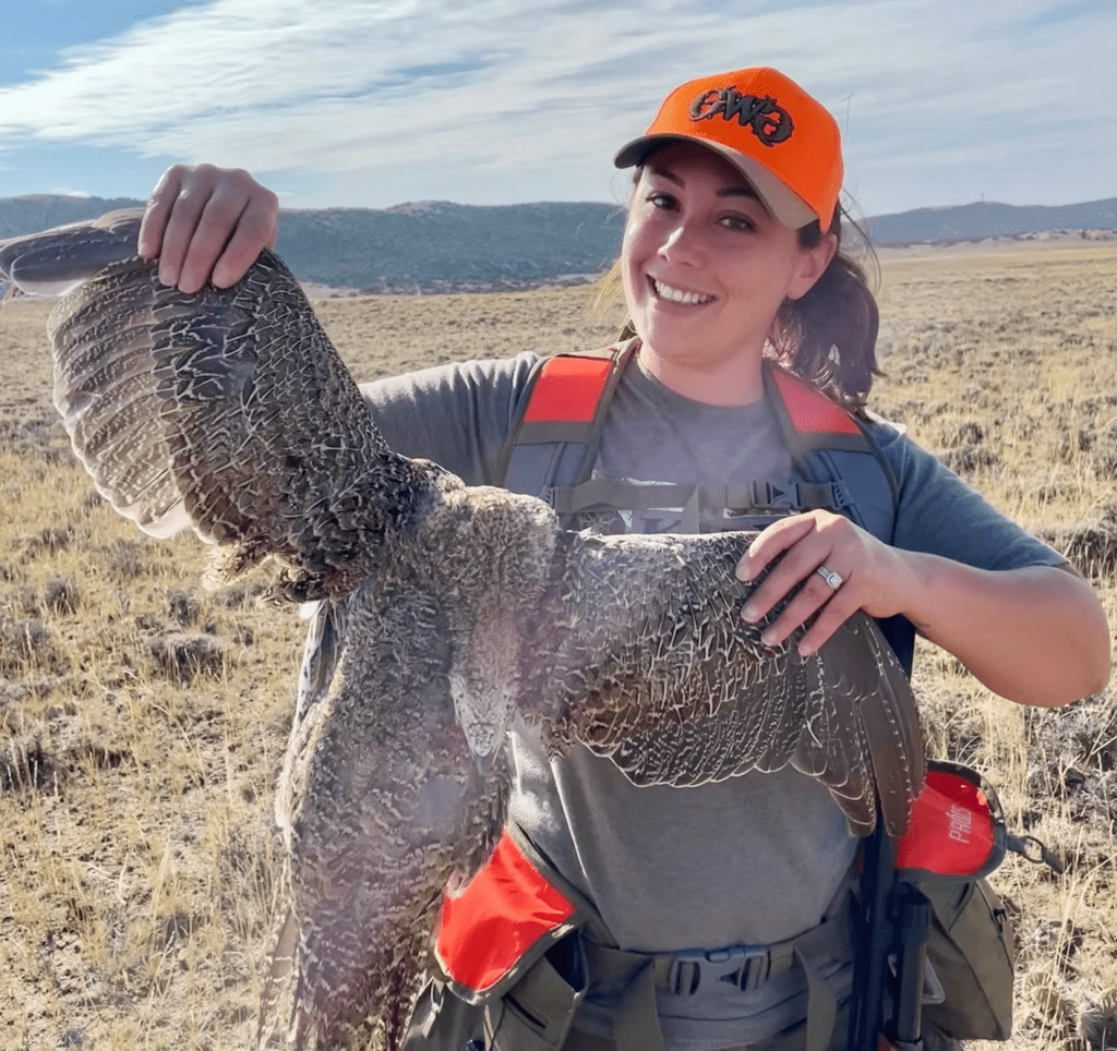 The author holding a sage grouse.