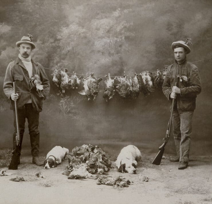 Two American hunters, one with a Pointer and the other with an English Setter.