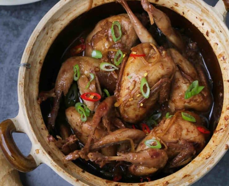 Whole quail braised in ginger served in a Vietnamese clay pot