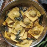 A pot of ravioli filled with braised woodcock, tossed with a butter-sage sauce