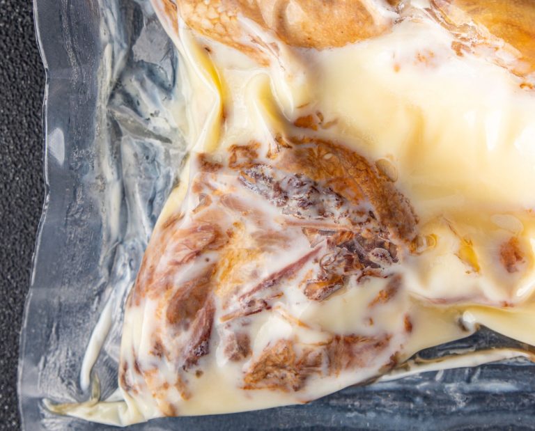 Duck fat in a sous vide with duck meat for duck confit