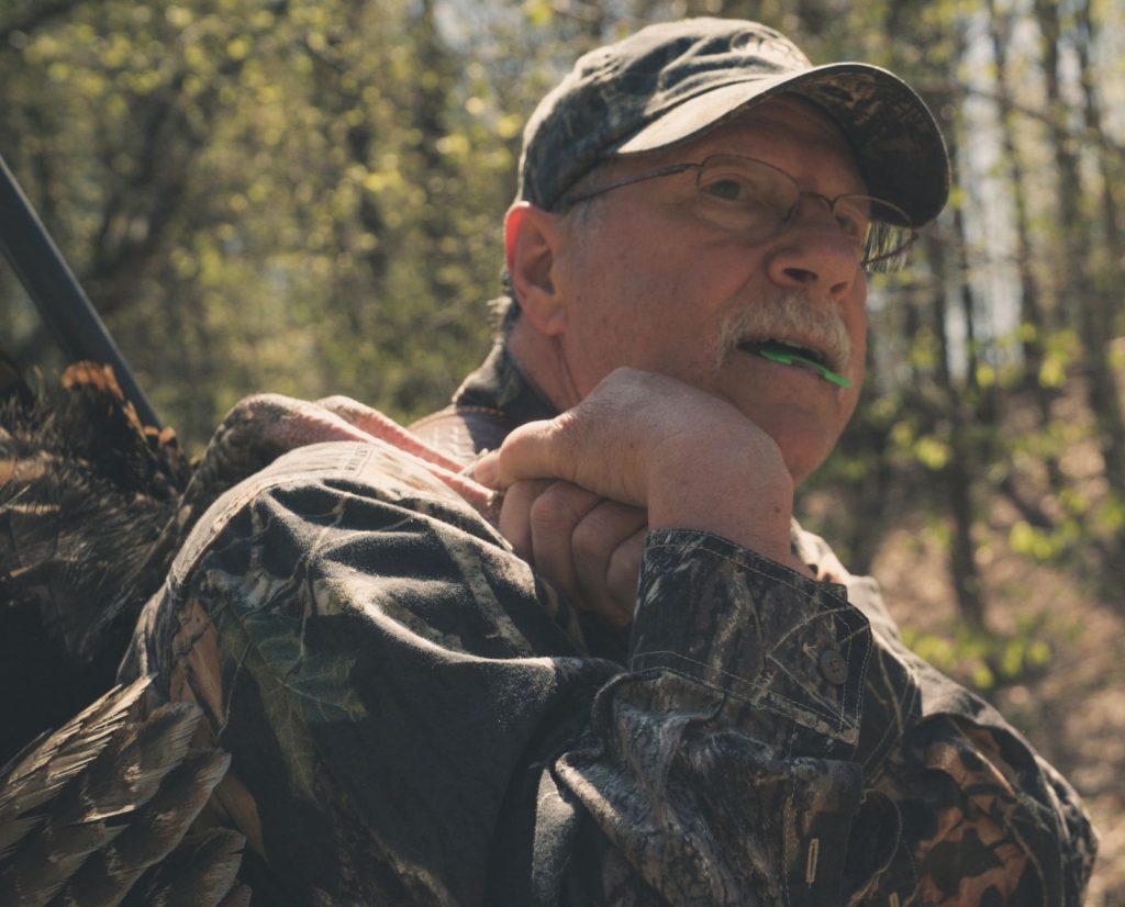 A spring turkey hunter holding a diaphragm call he used to hunt a gobbler.