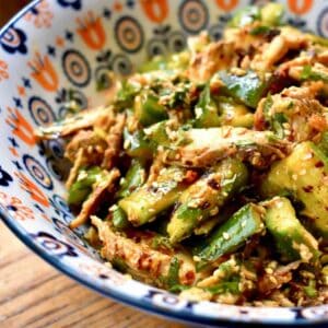 Shredded grouse meat and smacked cucumbers are tossed with an Asian sesame dressing and served in a colorful bowl