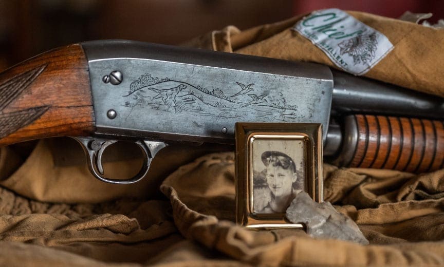 A pump shotgun and old hunting vest. 
