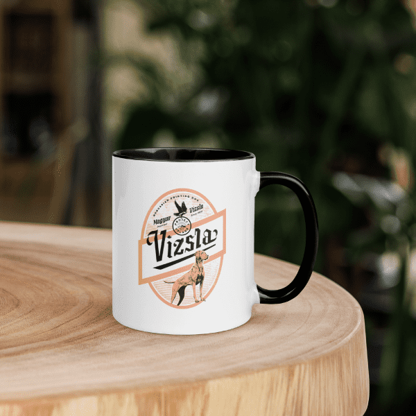 Vizsla-Coffee-Mug-in-Use A Vizsla ceramic coffee mug set on a table
