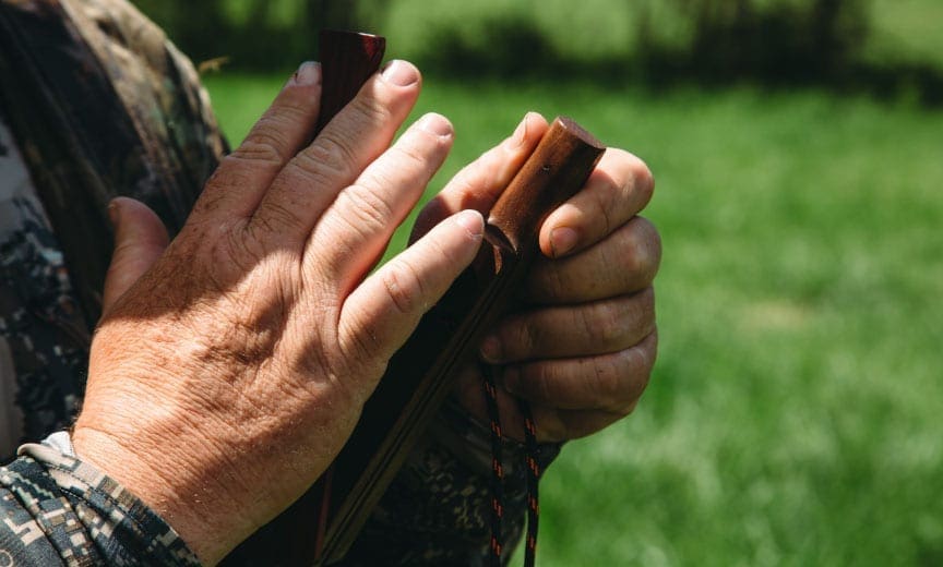 A turkey hunter uses a box call to locate turkeys. 