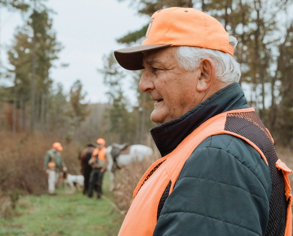 An elderly hunter quail hunts with a small group in the South.