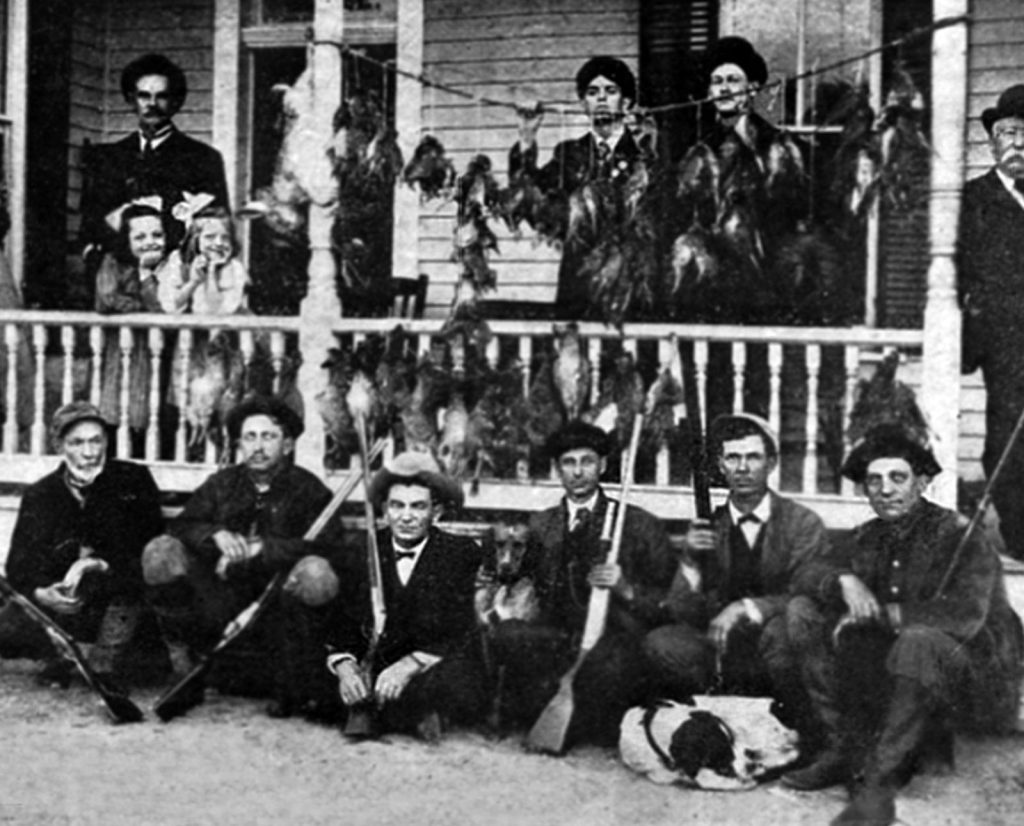 Attwater's prairie chicken hunters with their shotguns and dogs in 1907.