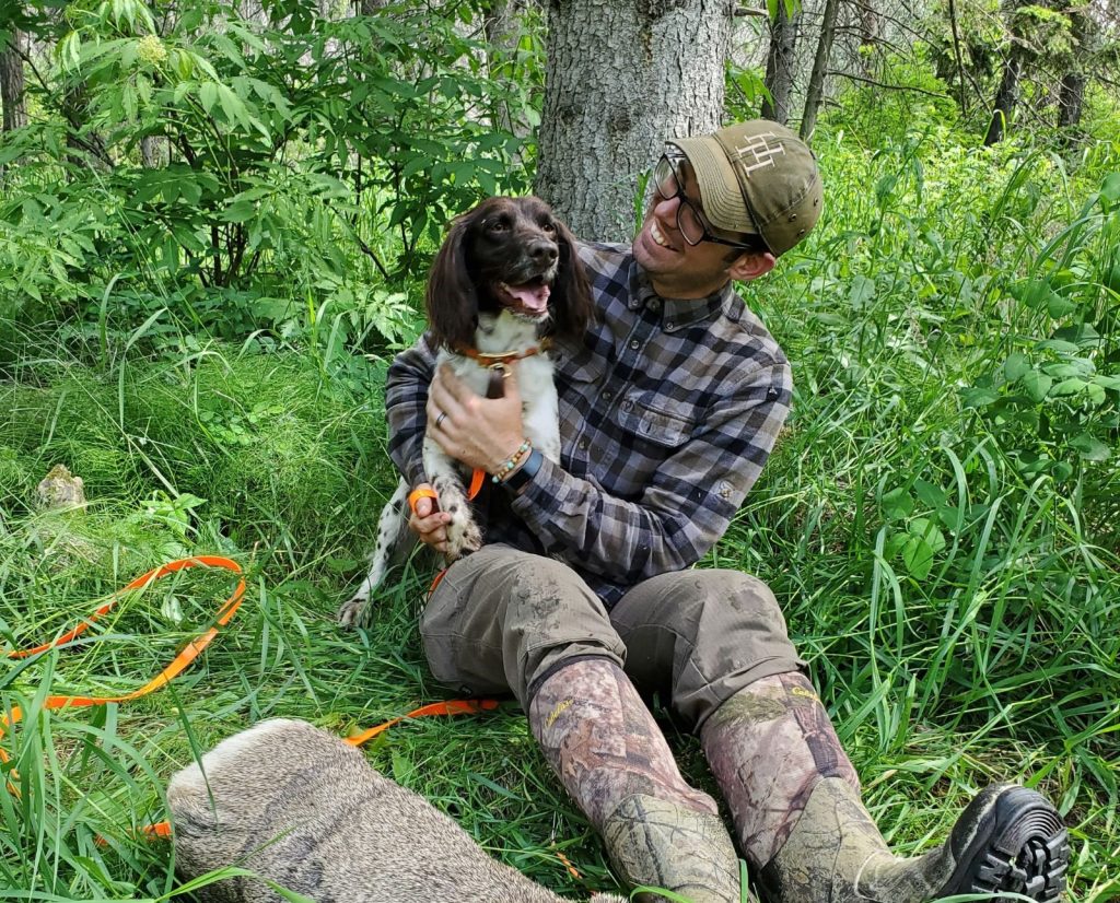 A Deutscher Wachtelhund and its handler celebrate after a successful blood track.