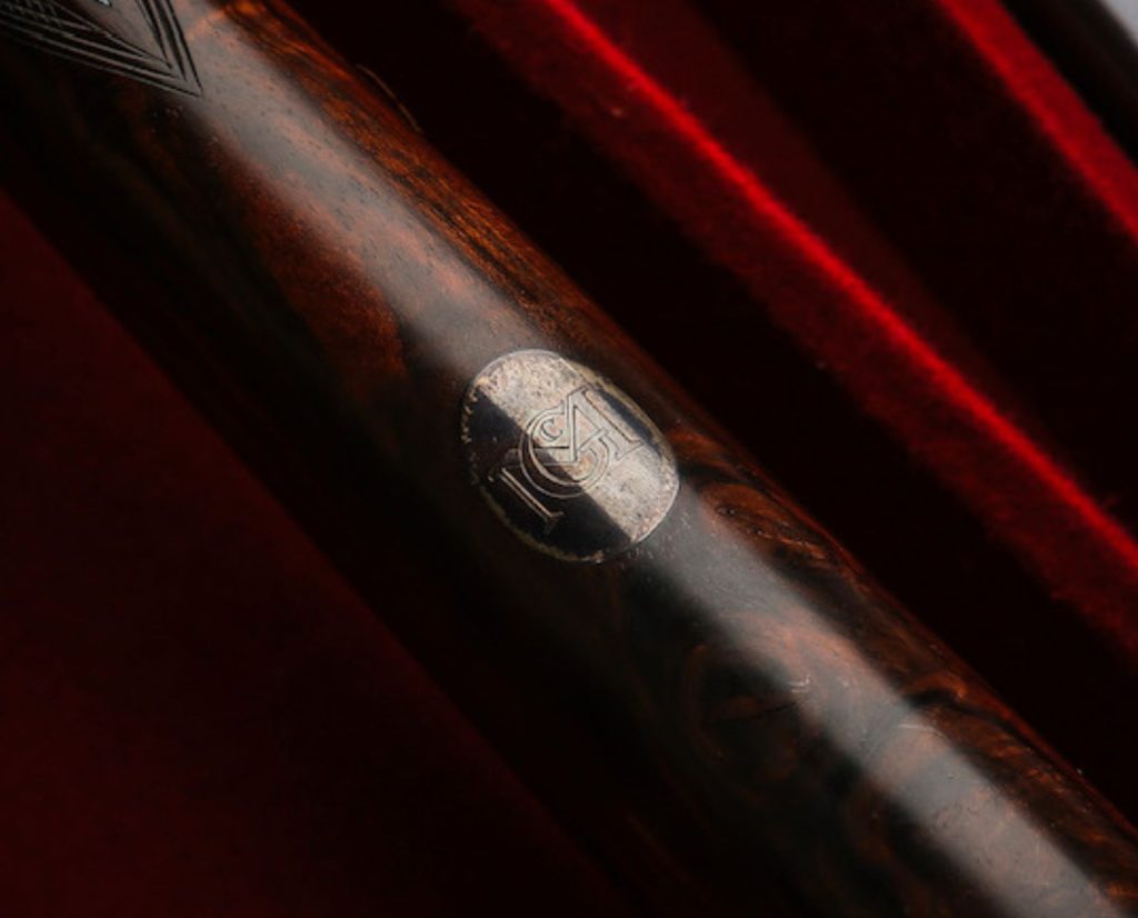 A classic 1920s monogram on an escutcheon, or shotgun stock oval.
