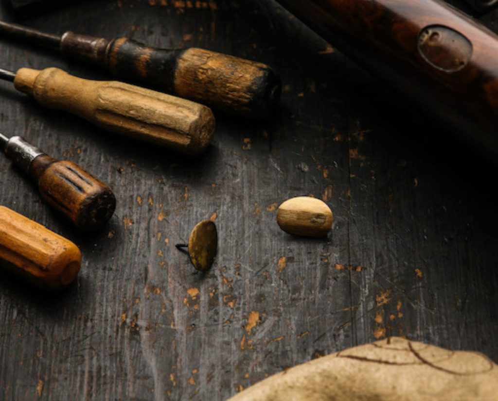 Escutcheon being replaced on a Purdey shotgun.