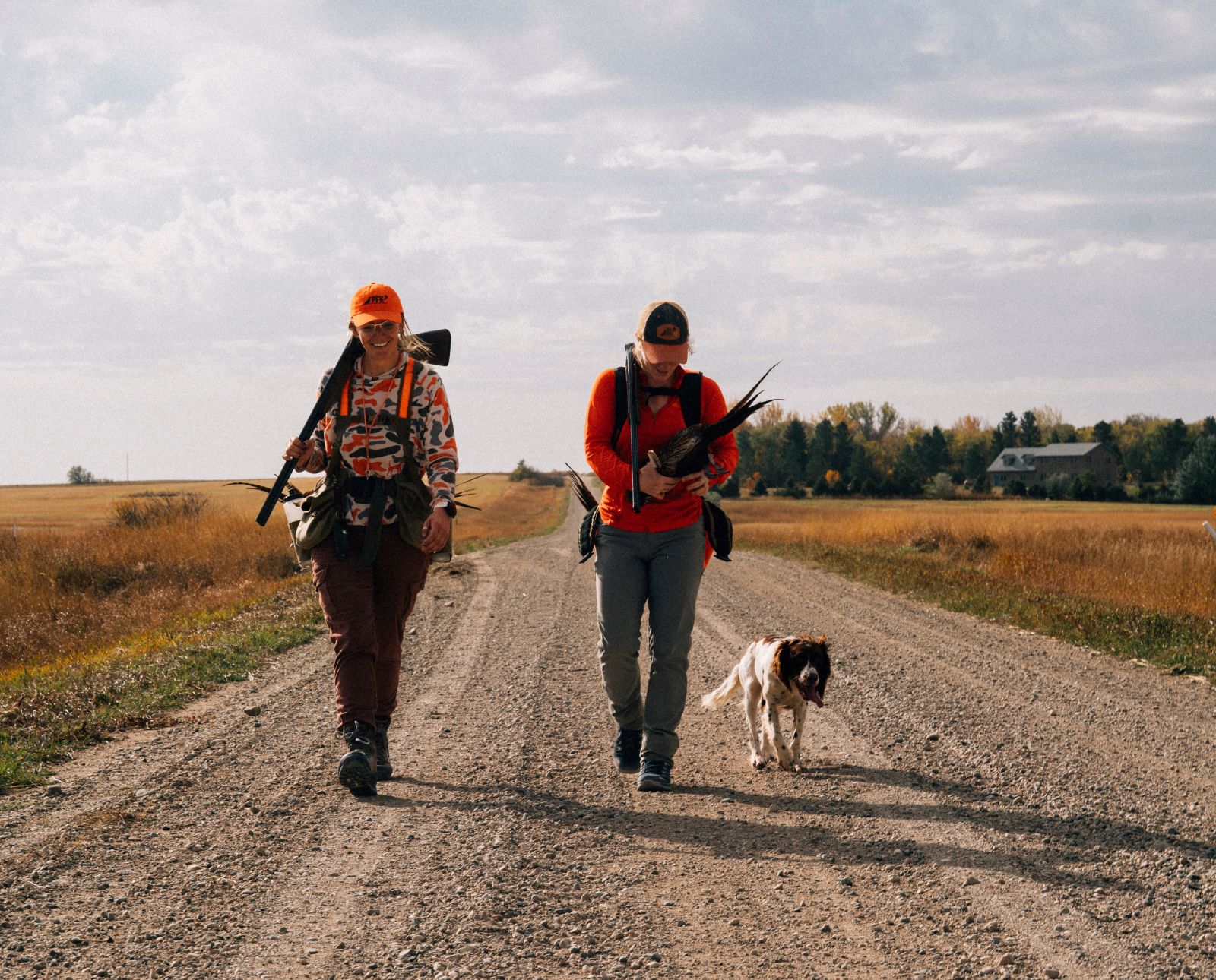 Two hunters who asked permission to hunt on private land with a bird dog and a pheasant.