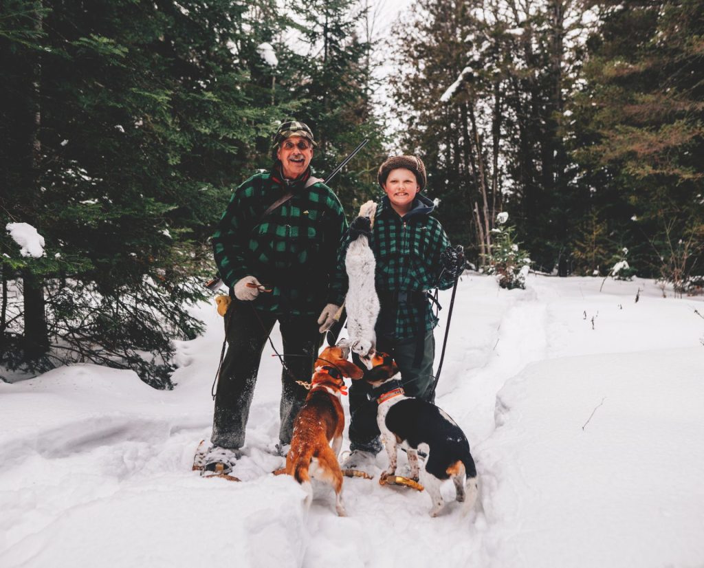 Two small game hunters develop patience while snowshoe hare hunting with beagles.