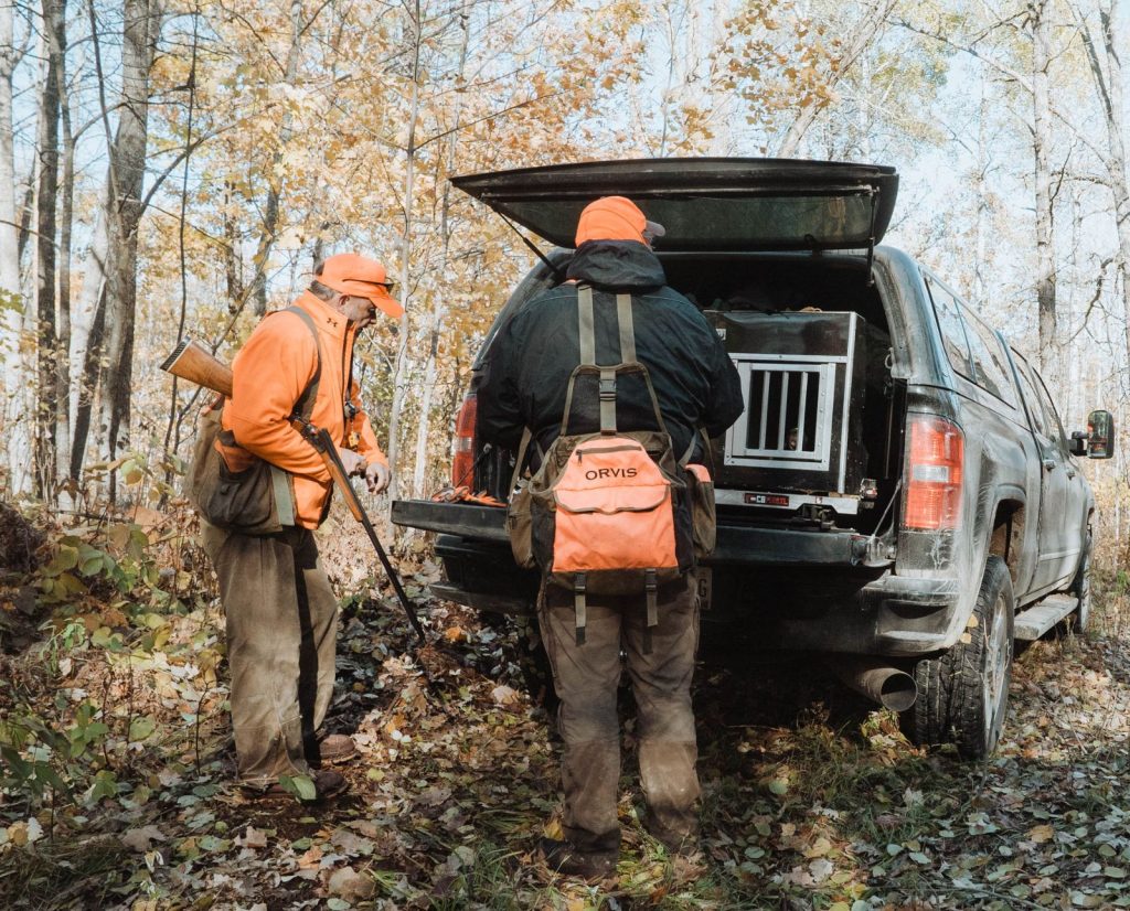 two bird hunters park at a spot near their small game hunting camp.